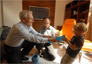 Two-year-old Evan plays with his dads, Kevin Yoder, right, and Harvey Hurdle at their Philadelphia home. 
